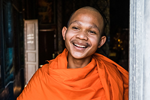 smiling monk contemplates desire